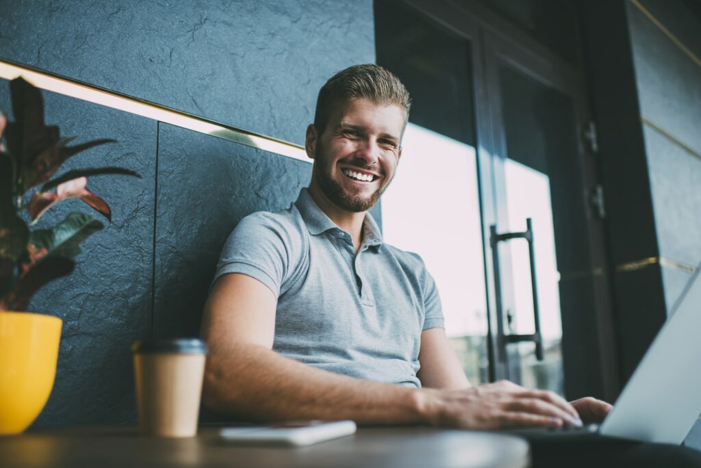 Happy man working on laptop during workday