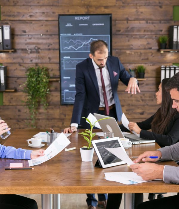 Business people having a brainstorm meeting in the conference room. Businessman in suit.